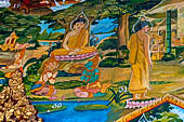 Luang Prabang, Laos - Wat Xieng Mouan with the faade decorated with brightly painted Jataka tales. 